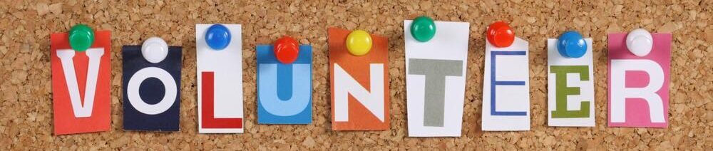 bulletin board with the word volunteer posted